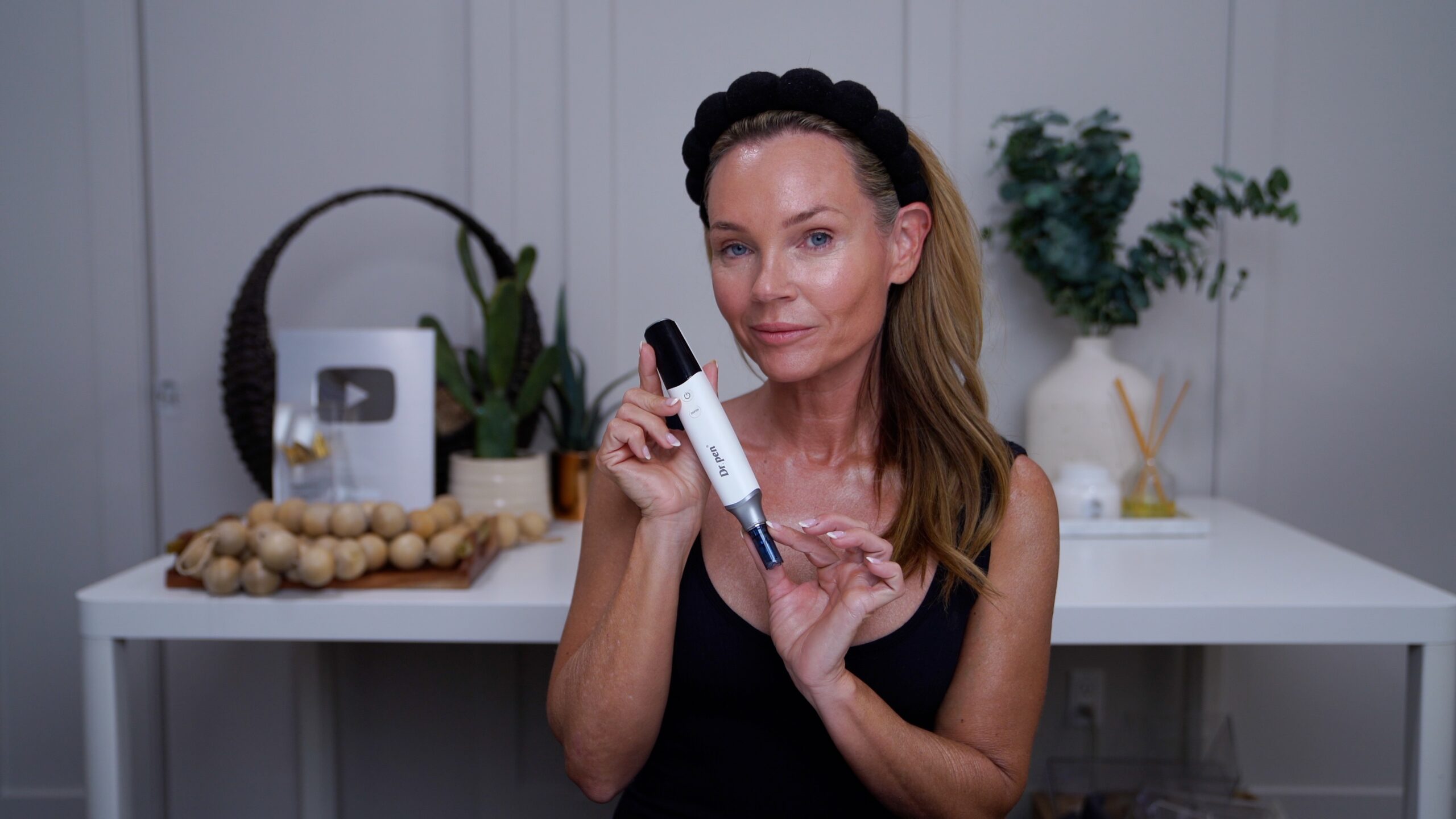 Kim holding a Dr. Pen M9 microneedling device