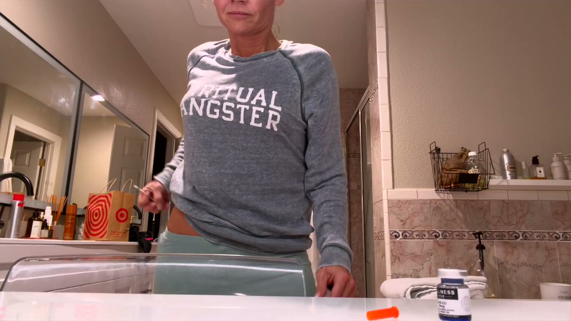 Kim Pratt holding a syringe near her hip before a documented GHK-Cu injection