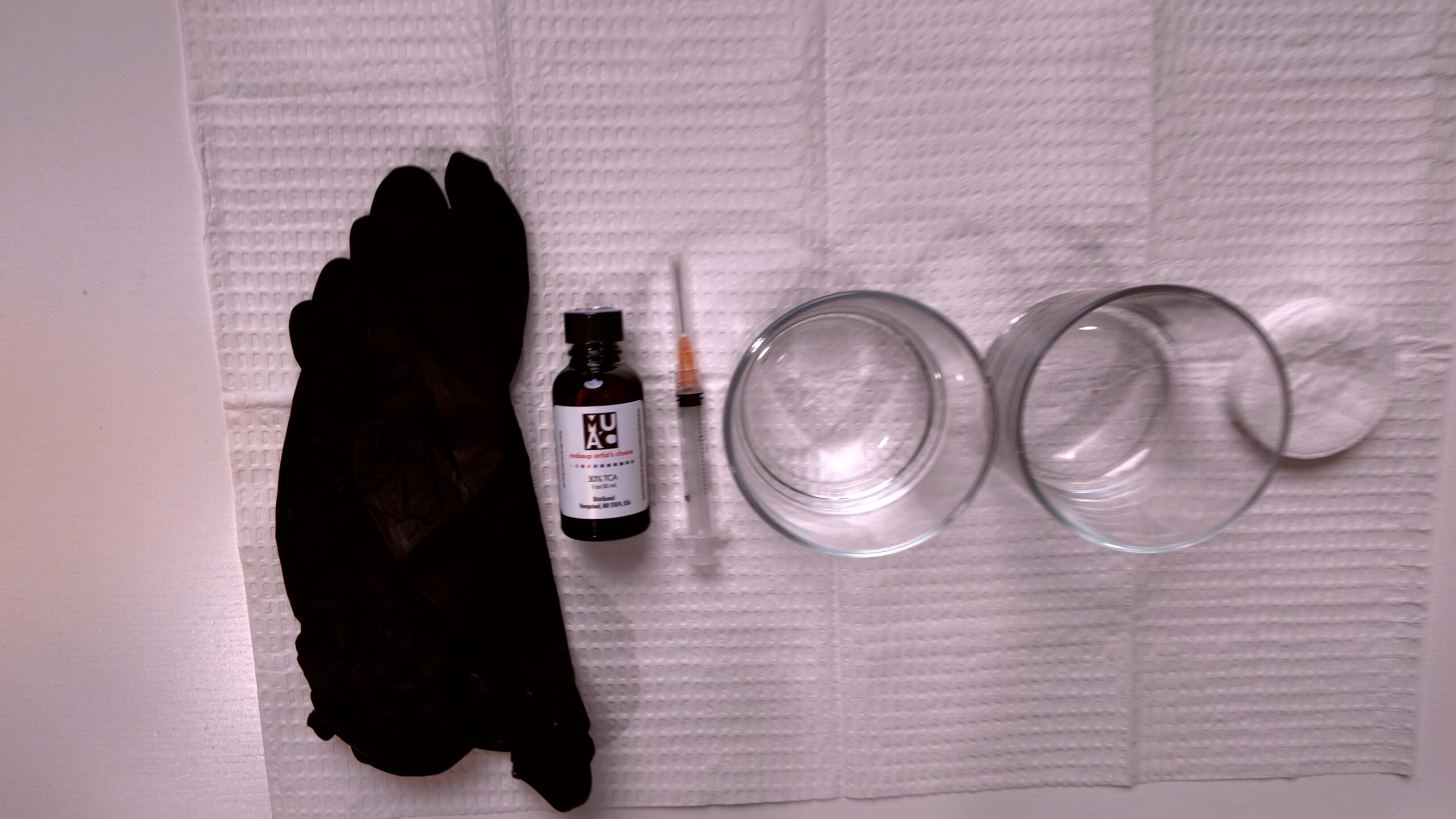 Gloves, dishes, cotton rounds, timer, cool blow-dryer, and recovery products arranged for my peel